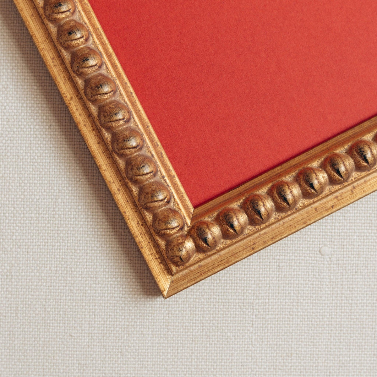 Detailed image of handmade bobbin frame in antique-style gold.