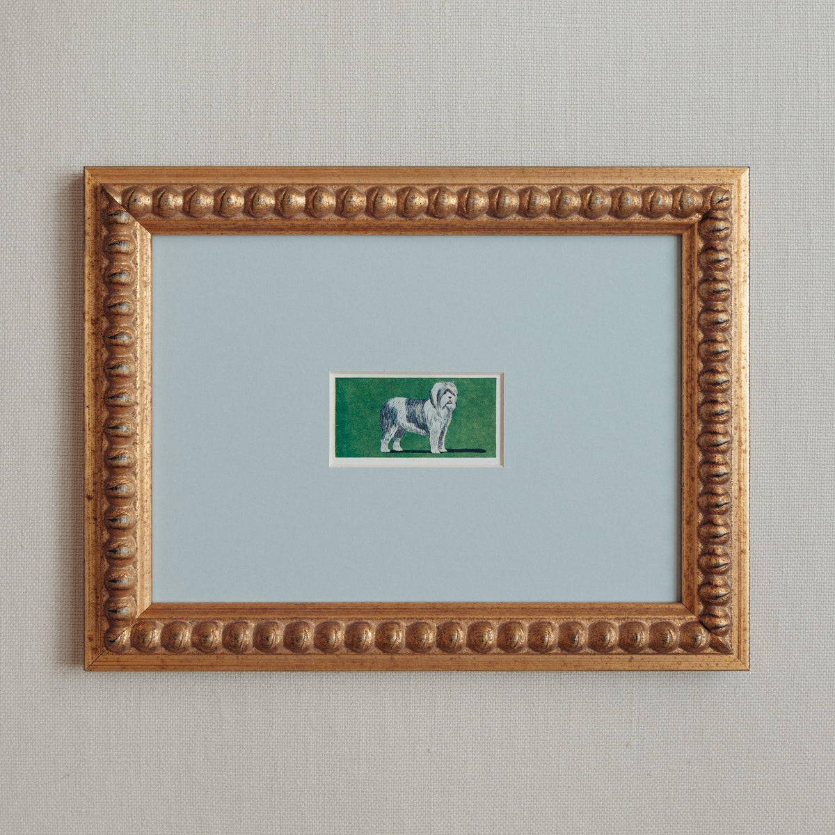 Handmade bobbin frame in antique style gold with blue mount framing a mid century lithograph of an old english sheepdog. Only available at Giddy Prints. 